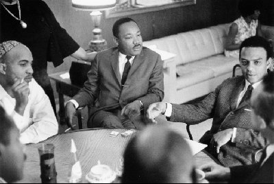 Dr. Martin King, Jr., Andrew Young and others in a strategy meeting on the movement.